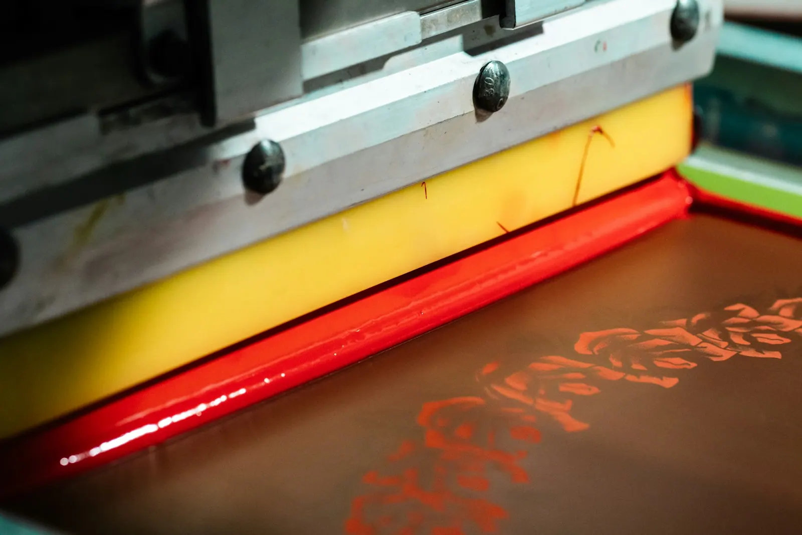 Close-up of screen printing with red ink. How to Screen Print at Home with a Vinyl Stencil